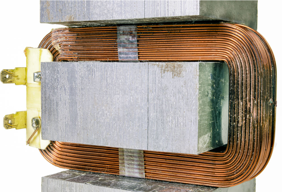 Photo of a reactor coil with visible copper windings and iron core